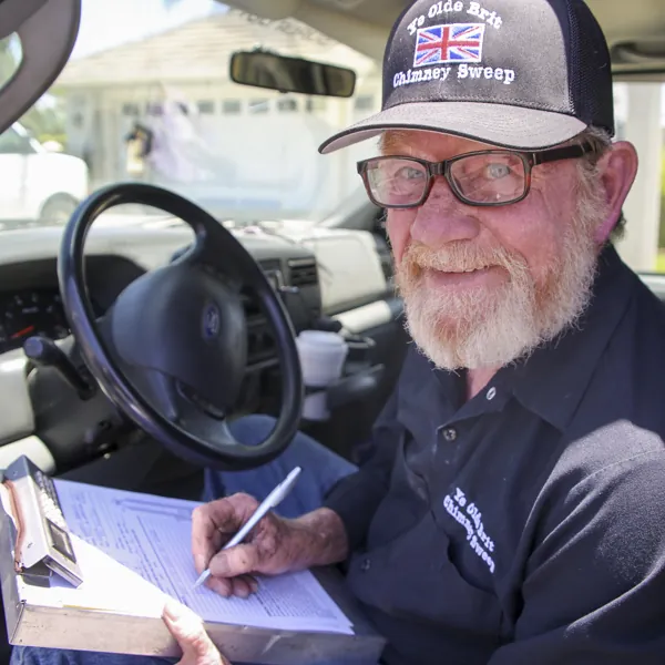 The owner in the work truck, writing up the day's paperwork